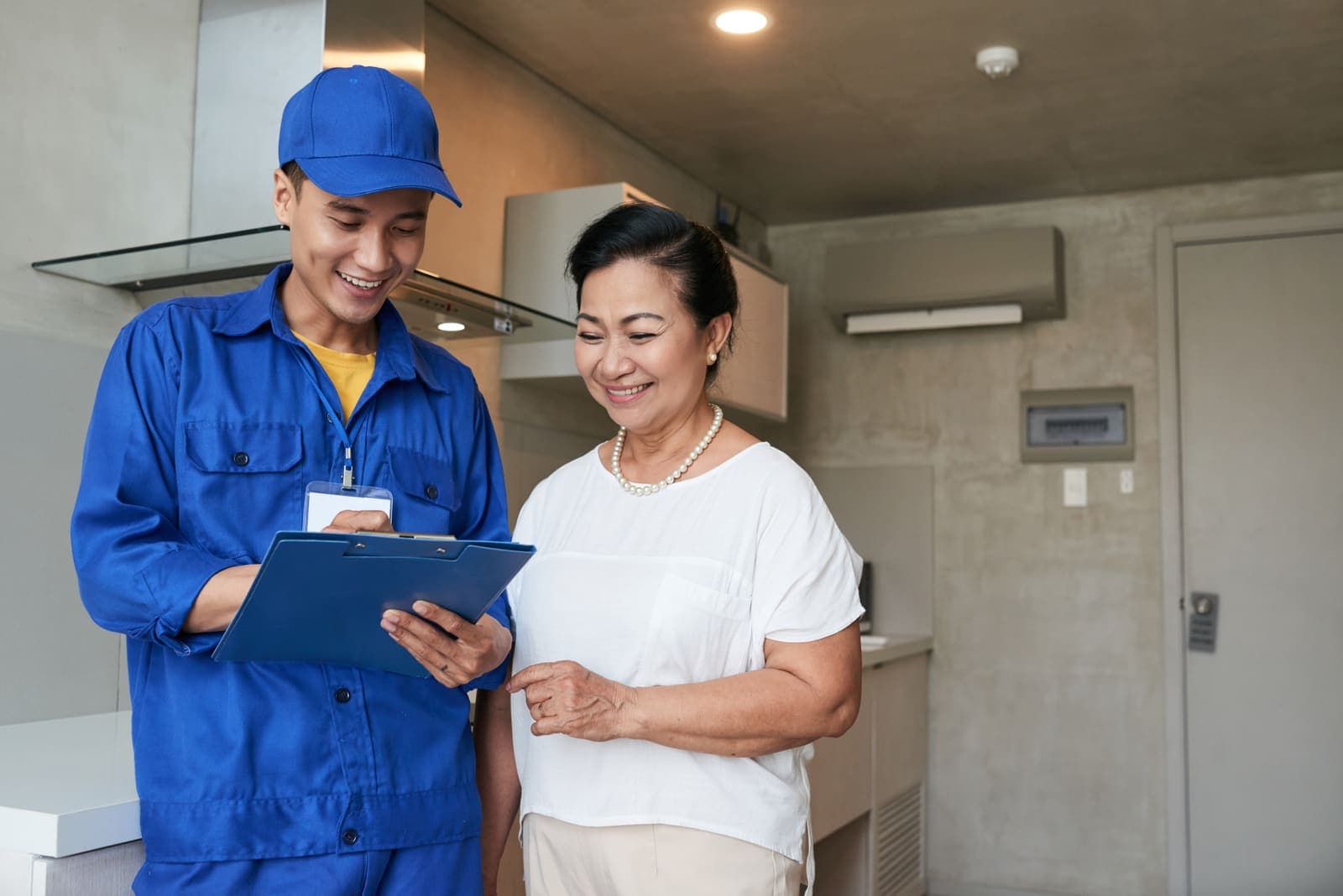An HVAC technician talking with a homeowner