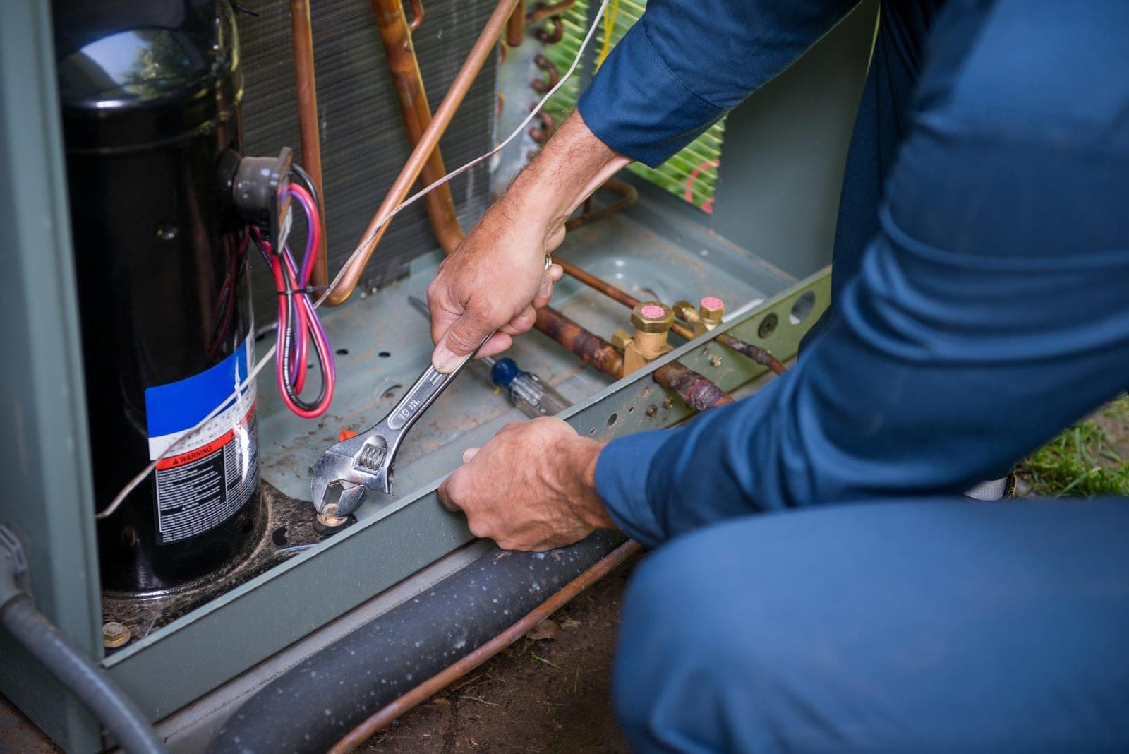 An HVAC technician working on a home heating system