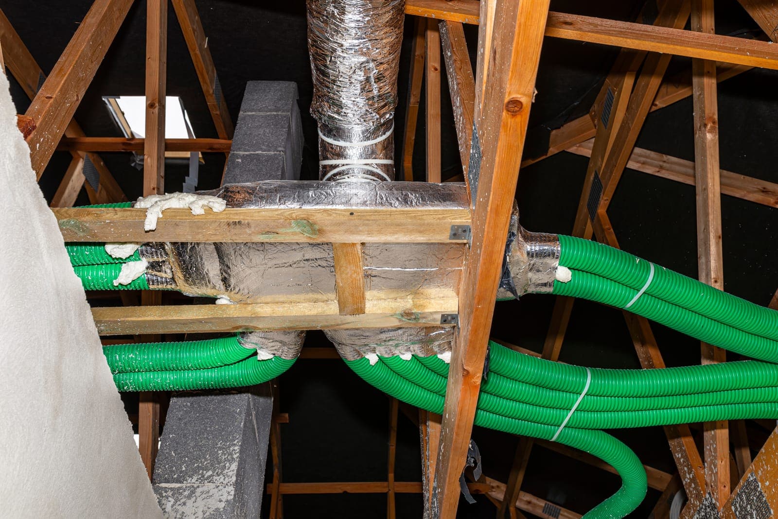 Exposed HVAC ductwork running through a home attic