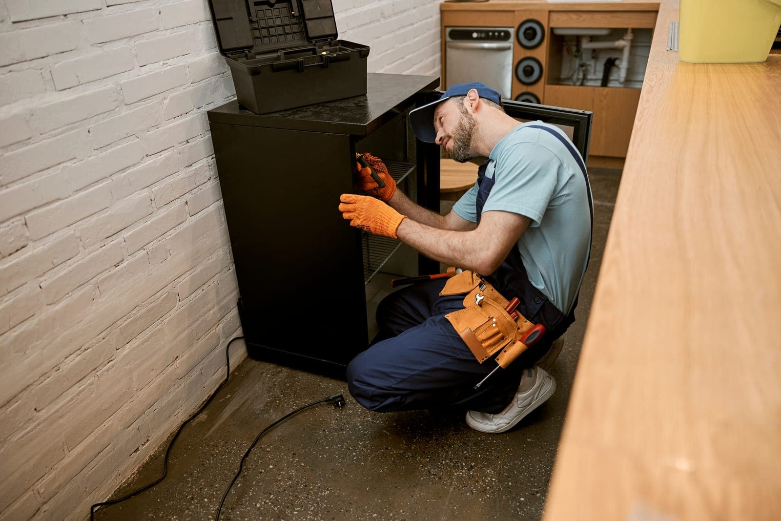 An HVAC technician servicing a home furnace during a fall tune-up
