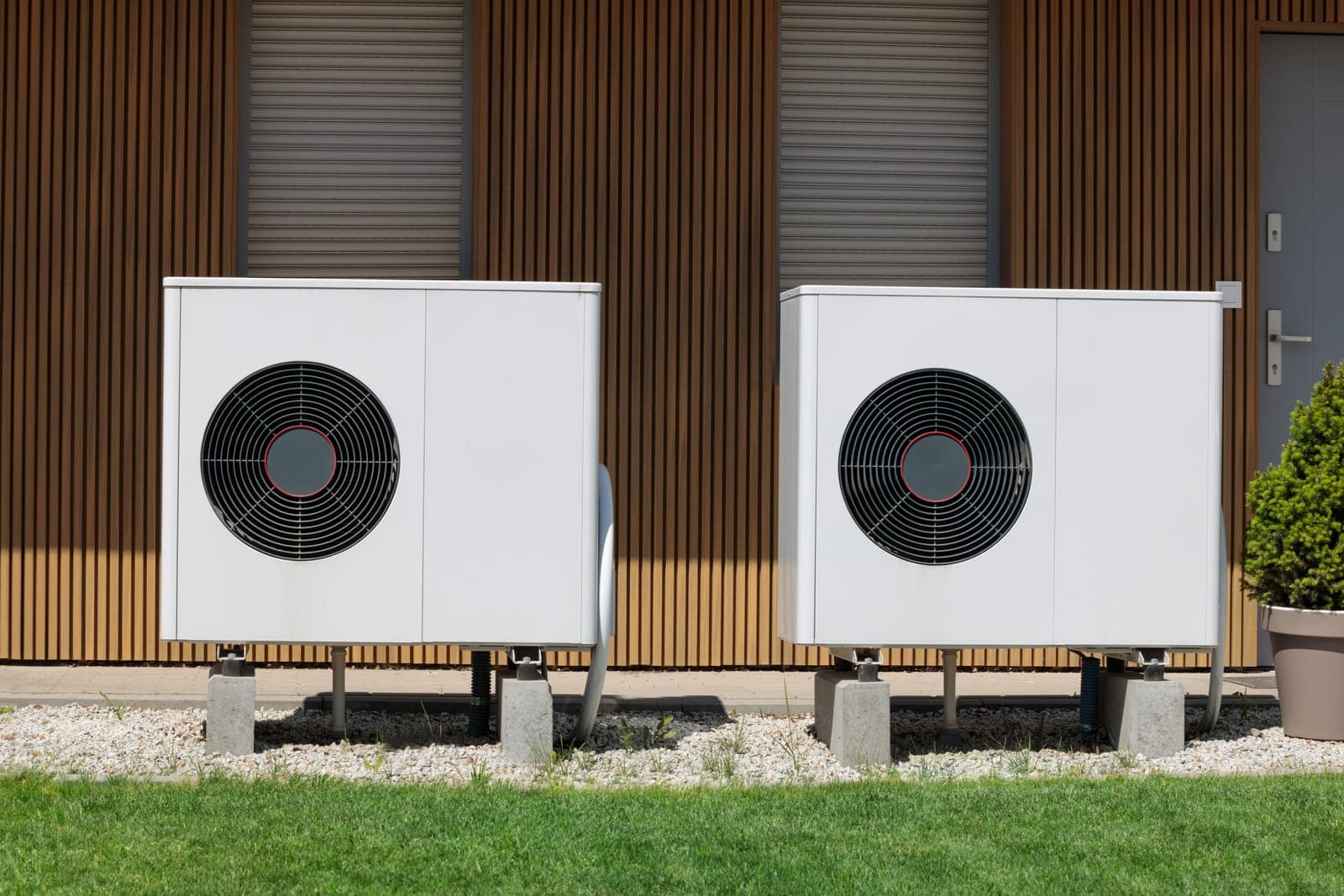 Two outdoor HVAC units installed side by side at a modern home