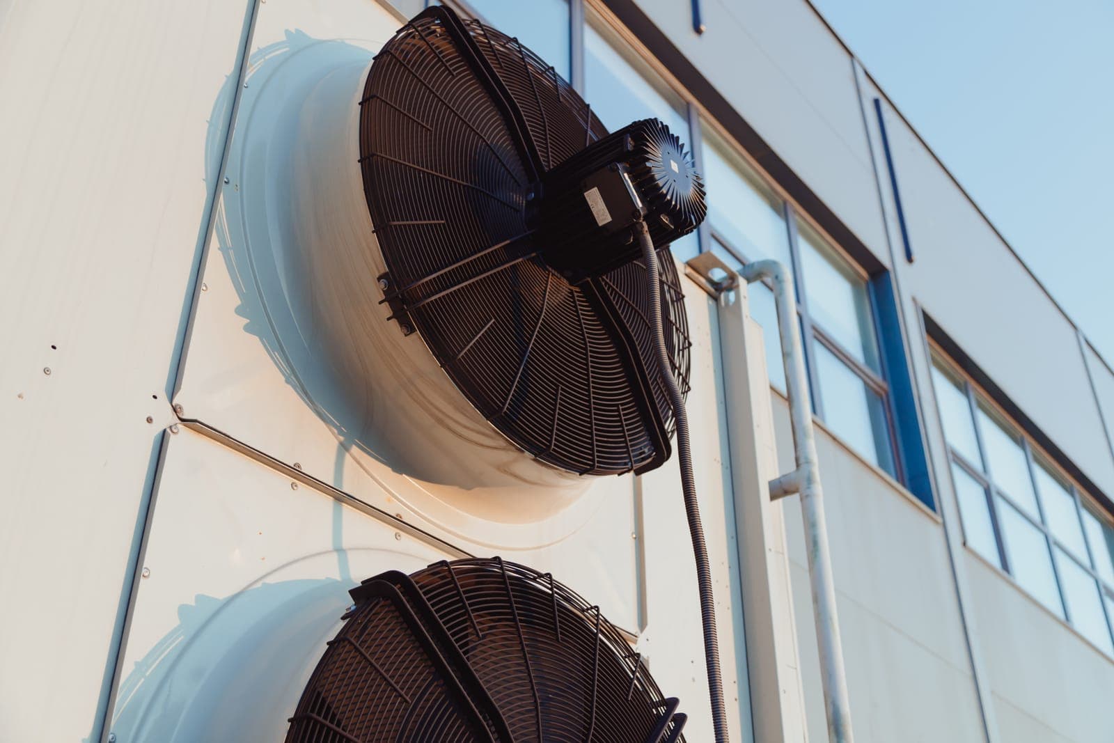A close-up of an outdoor air conditioner condenser fan