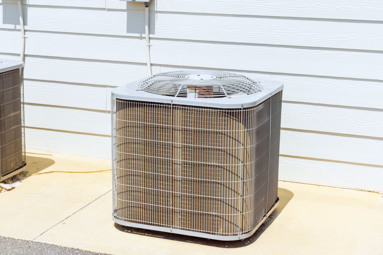 A central air conditioning condenser unit outside a home