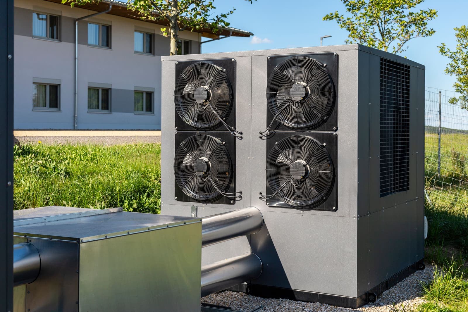 An efficient heat pump system on a green lawn