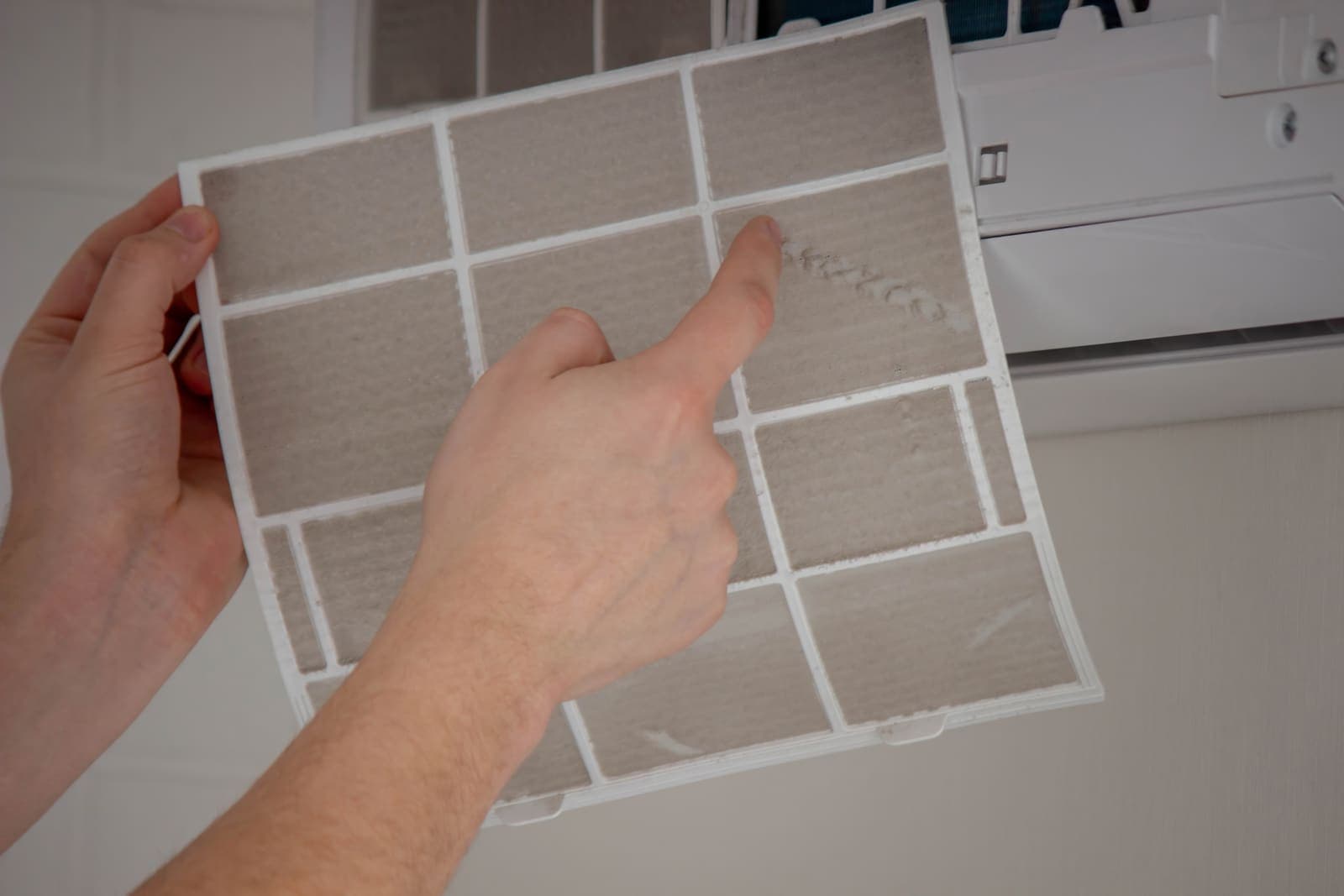 Checking a home air conditioning filter for dust